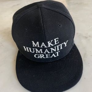 Corie Mattie MAKE HUMANITY GREAT Trucker Hat in Black